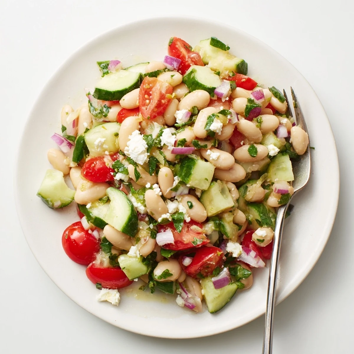 Vibrant Mediterranean White Bean Salad, brimming with fresh vegetables and creamy feta cheese, ready to enjoy.