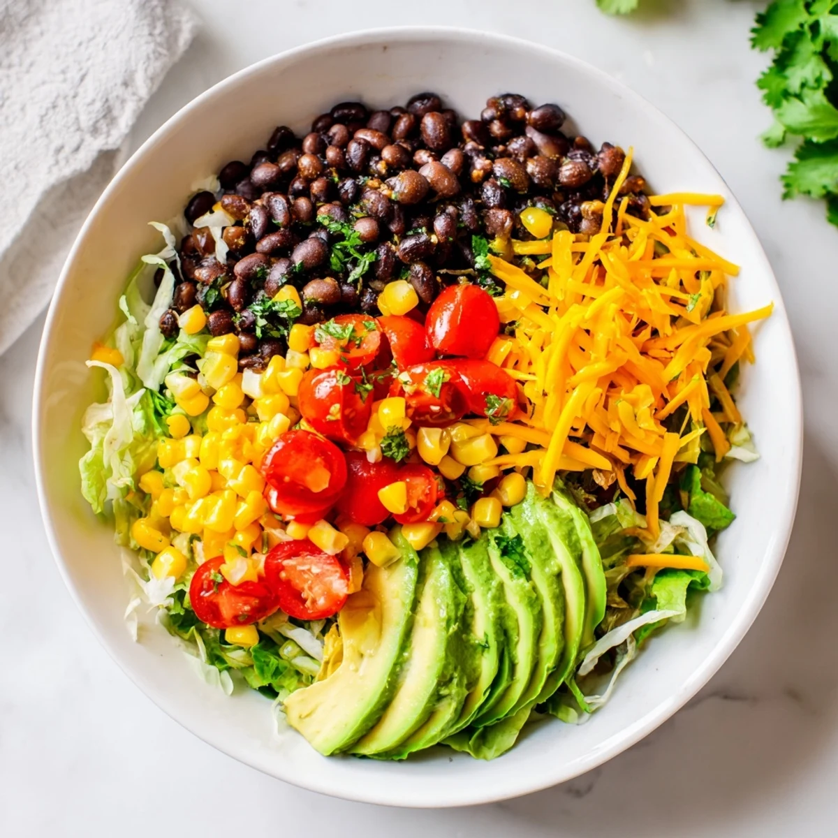 This Southwest Sunset Palette showcases colorful layers: bell peppers, cheese, and beans, a feast for the eyes and the taste buds.