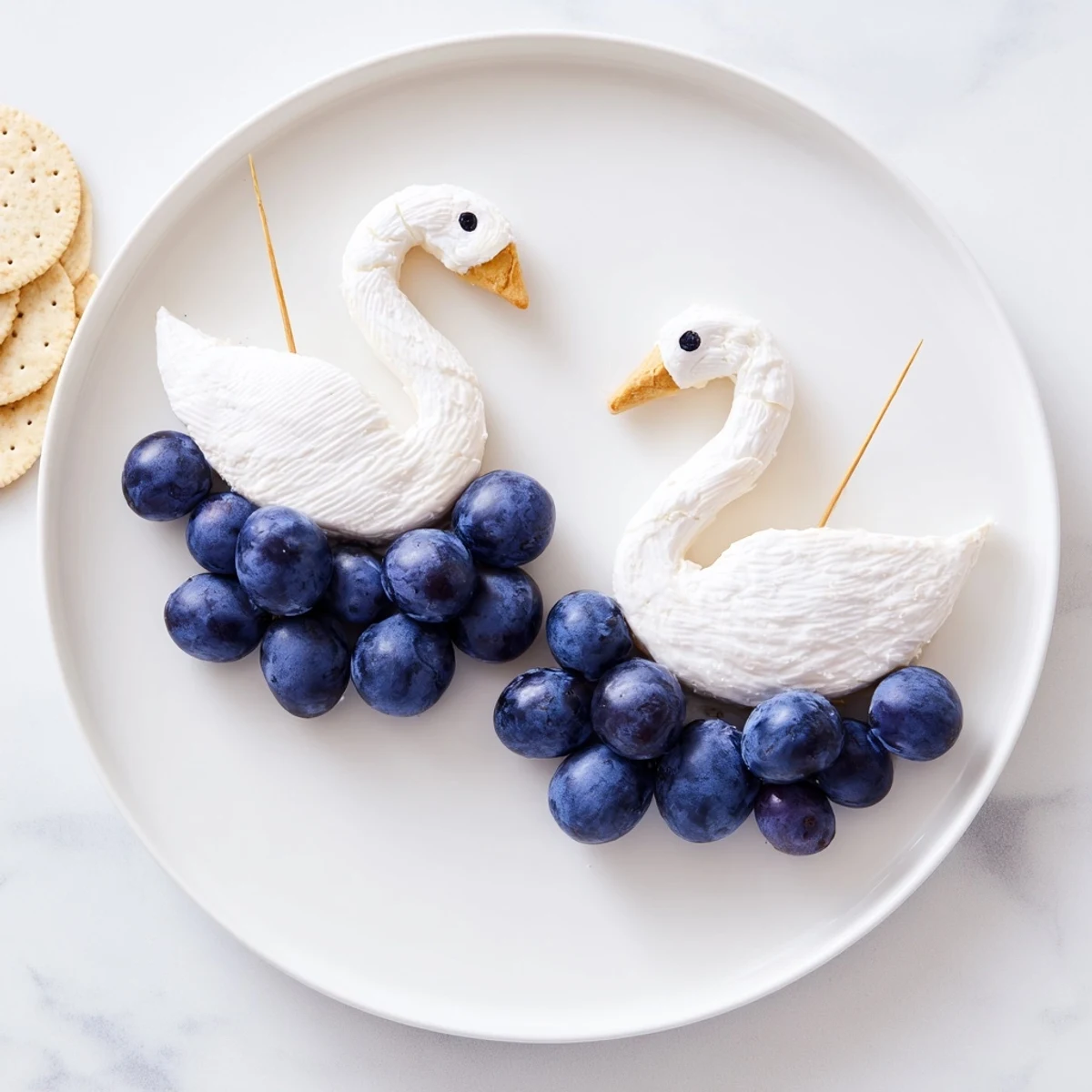 A beautiful Elegant Swan Lake Board with grapes and crackers offers a lovely cheese platter.