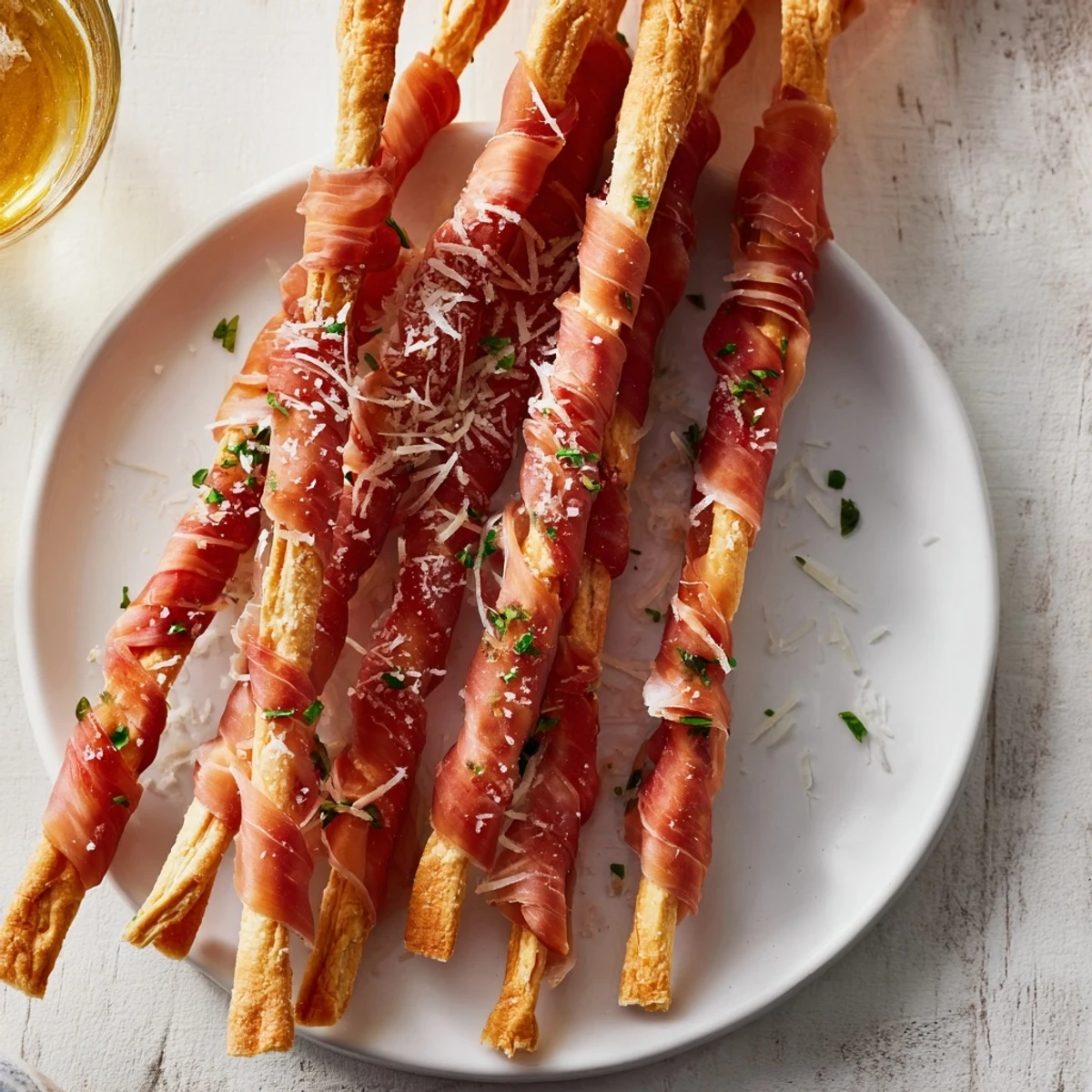 Golden Gate appetizer showcasing prosciutto draped artistically over crunchy breadstick towers, ready to eat.