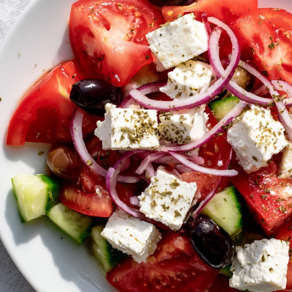 Vibrant overhead shot of a Mediterranean Salad ready to eat, featuring a zesty vinaigrette.