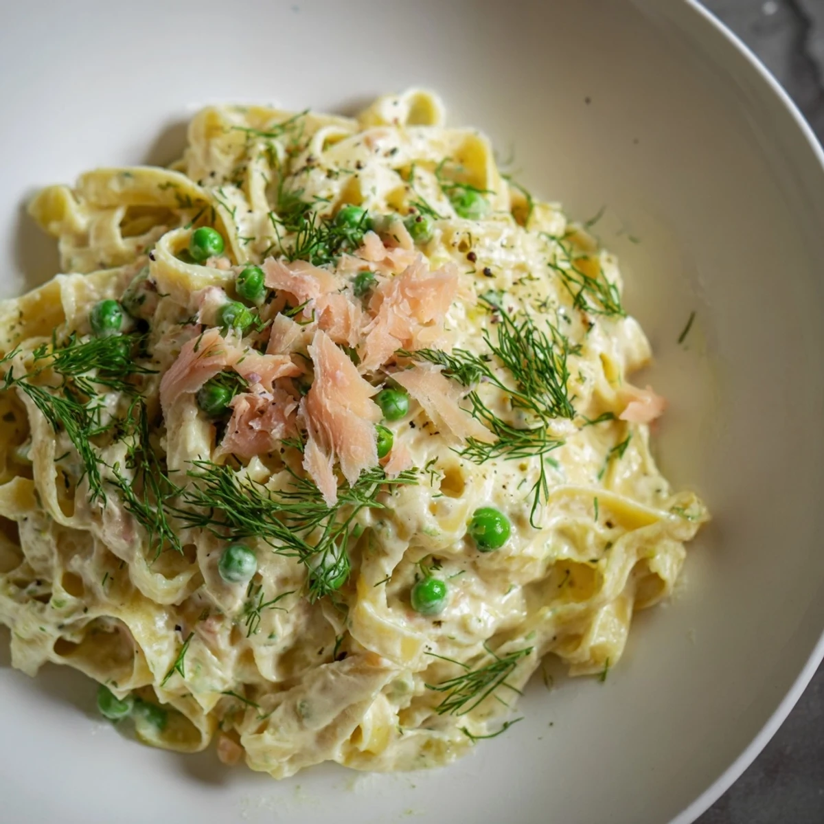 Close-up shot of the elegant creamy dill pasta, drizzled with lemon for a bright taste.