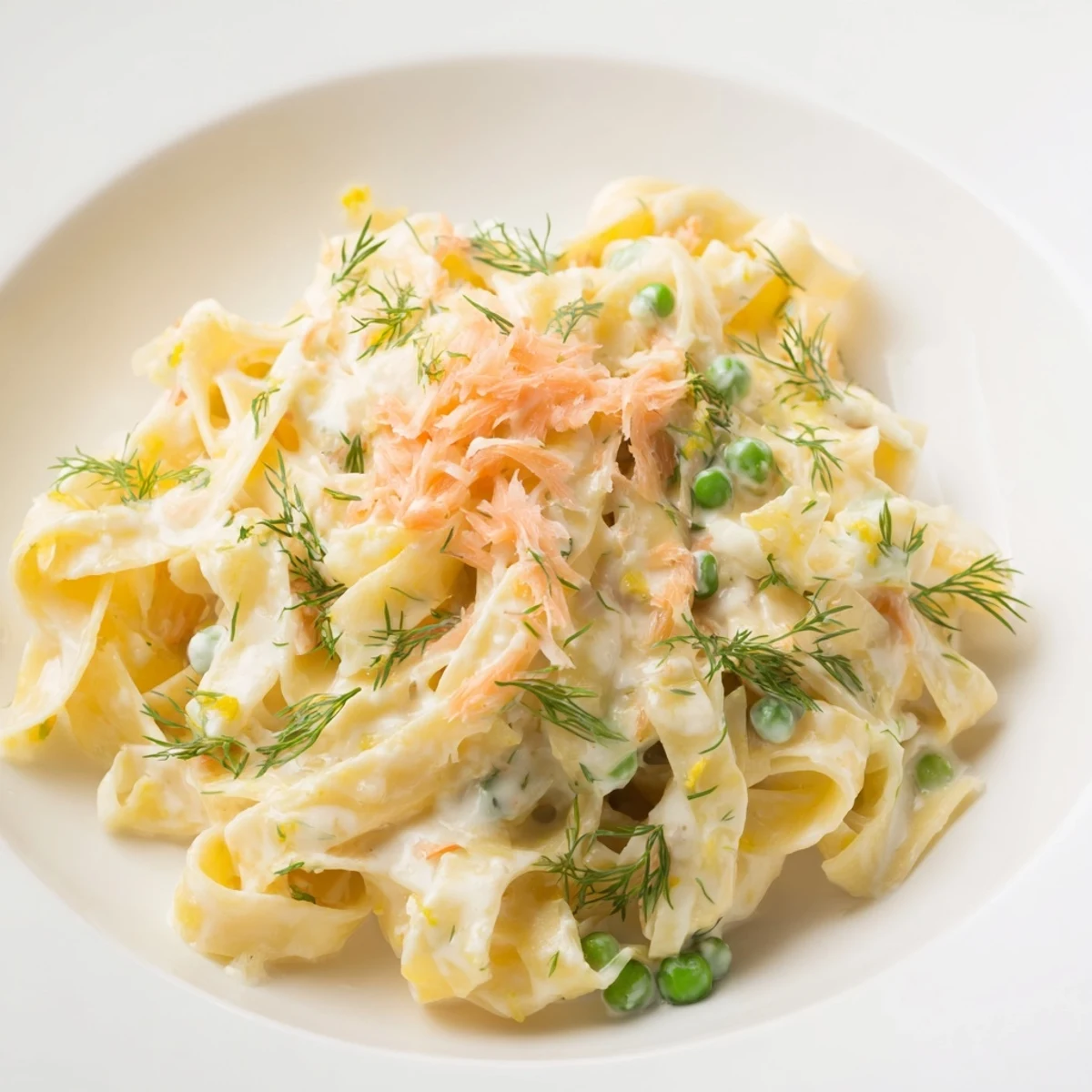 Golden swirls of creamy dill pasta, a comforting main course, ready to eat.