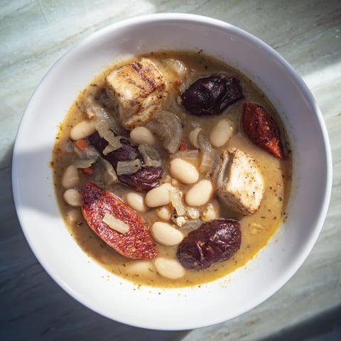 Steaming Budget Fabada Asturiana: a rich Spanish stew with tender white beans and smoky sausage.