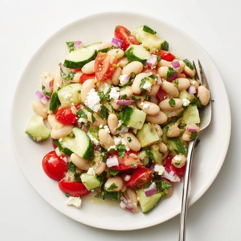 Vibrant Mediterranean White Bean Salad, brimming with fresh vegetables and creamy feta cheese, ready to enjoy.