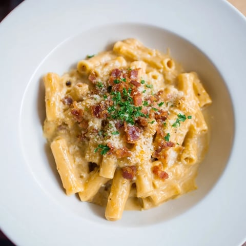 Golden, bubbly Sheet Pan Mac and Cheese with crispy bacon crumbles, ready to serve warm.
