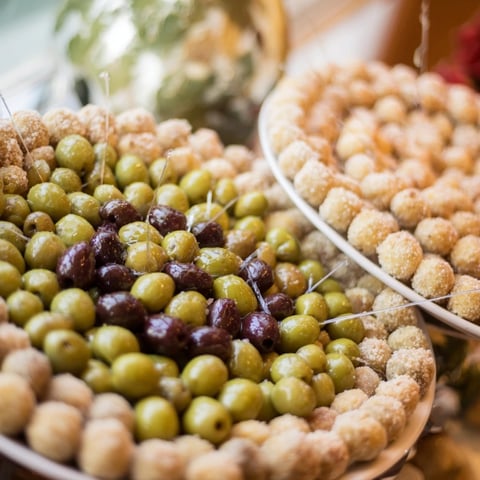 The Roman Colosseum snack platter with olives looks like a fun, circular party appetizer.