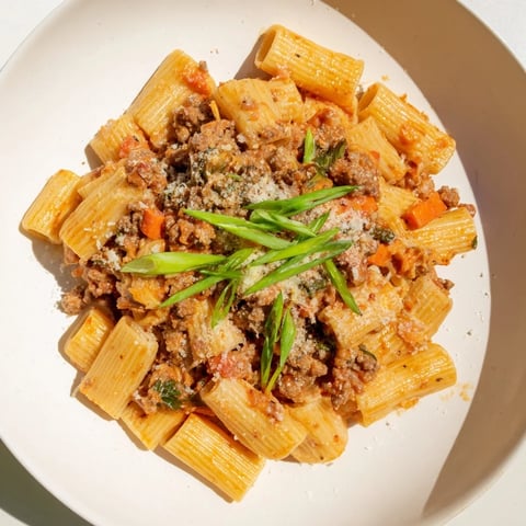Steaming hot bowl of Chaos Cooking Kimchi Ragu Pasta, ready to savor a delicious, spicy bite.
