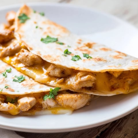 Golden, crispy Butter Chicken Quesadillas filled with melty cheese and tender, spiced chicken.