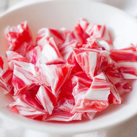 Melted peppermint candies forming a unique, festive no-bake peppermint candy bowl ready for treats.