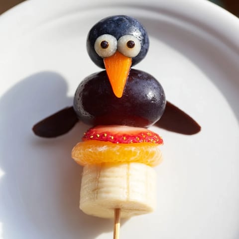 Vibrant Penguin Fruit Skewer Army display, showcasing fresh fruit skewers arranged for a delightful children’s party.