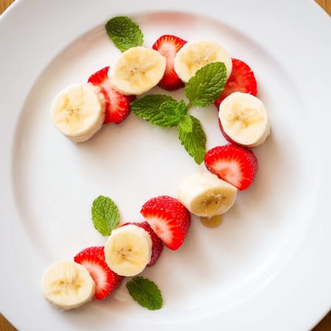 Freshly assembled Banana Strawberry Candy Cane: a festive, colorful holiday treat made with sliced fruit.