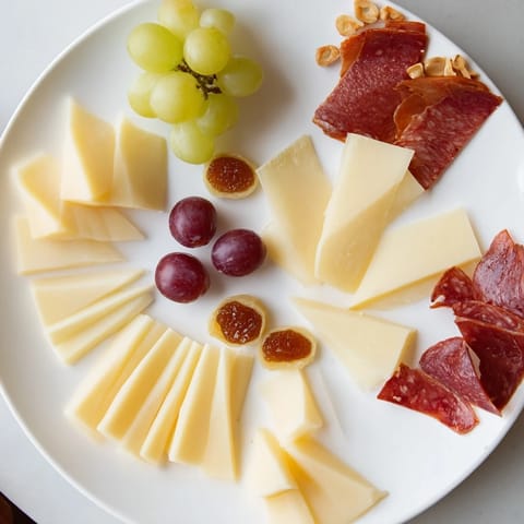 This Geometric Gala appetizer features beautifully arranged triangle-cut cheeses and salami for a party.