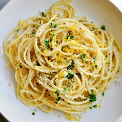 Close-up of buttery Garlic Butter Noodles with grated Parmesan, steaming and savory.