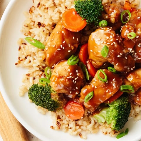 Tender chicken and crisp broccoli florets rest atop fluffy rice in a savory honey garlic glaze in this one-pan meal.