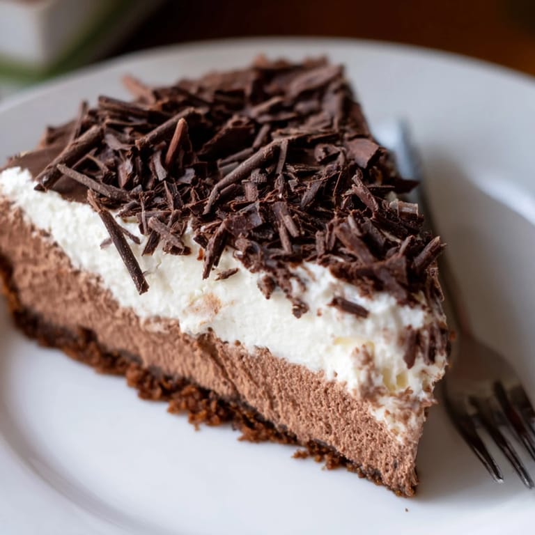 A beautifully set chocolate cottage cheese cheesecake with a graham cracker crust, ready to serve after chilling.