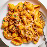 Creamy One Pot Beef and Shells pasta in a skillet, garnished with fresh parsley and melted cheddar, ready for a cozy dinner.