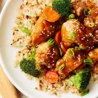 Tender chicken and crisp broccoli florets rest atop fluffy rice in a savory honey garlic glaze in this one-pan meal.